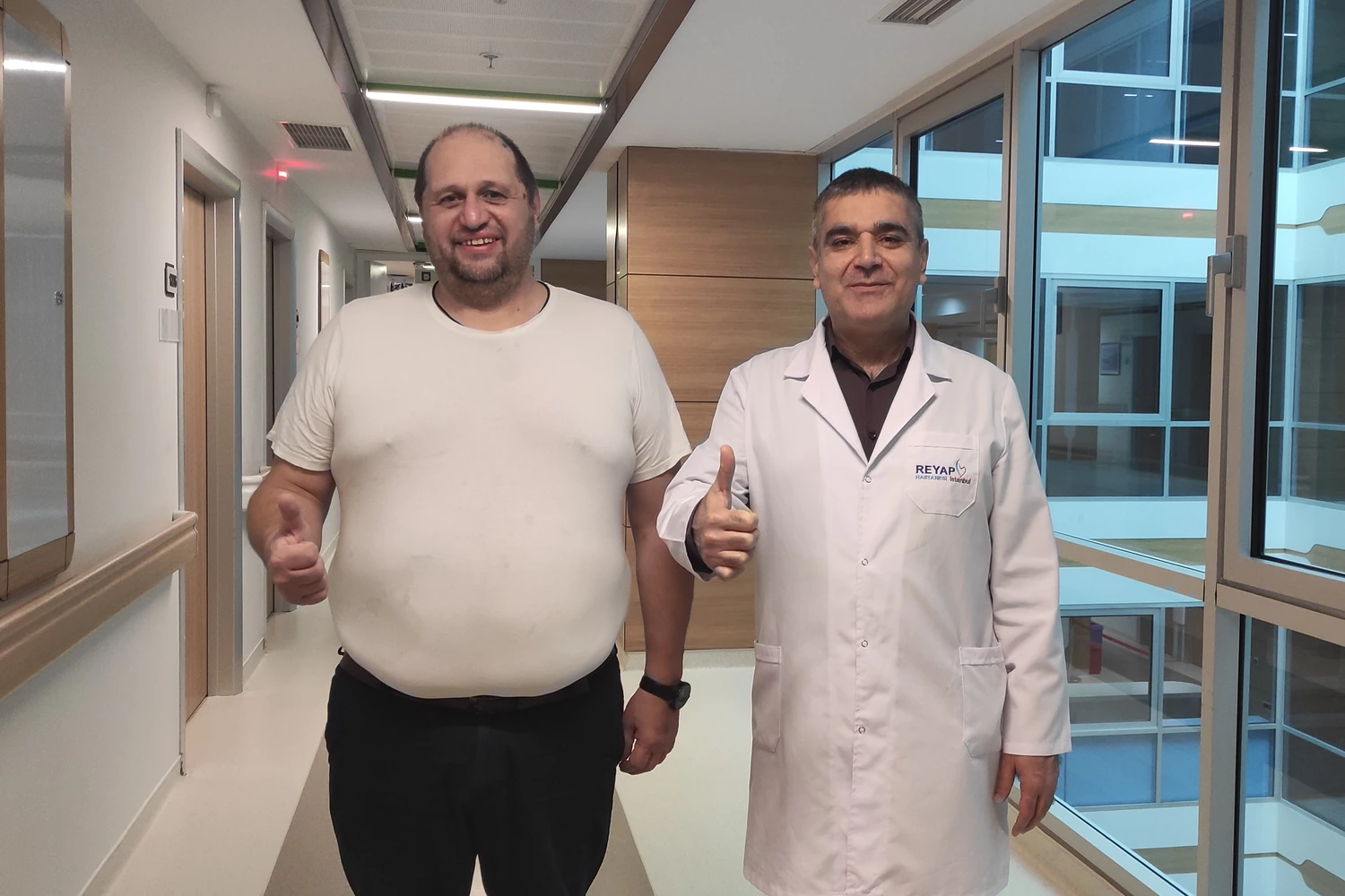 International patient with his surgeon in the hospital corridor