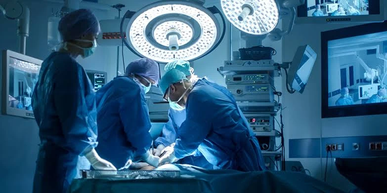 A surgical team operating in a hospital theatre